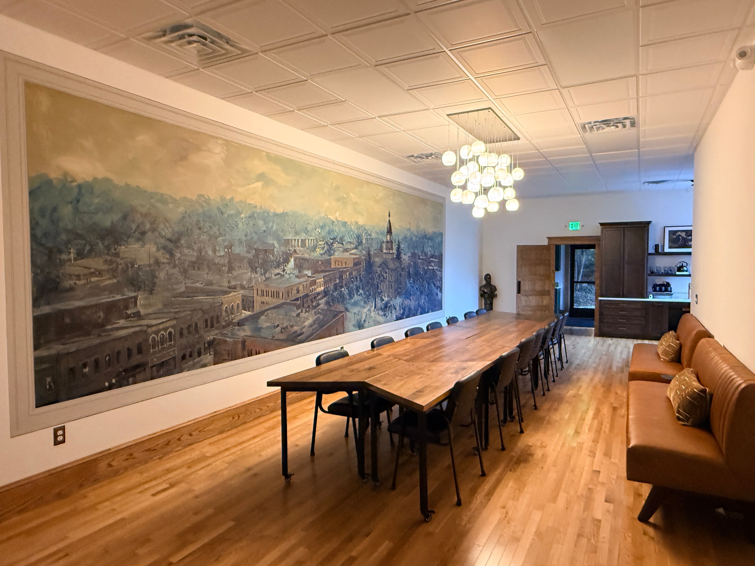 The long table and chairs beside the Hillsdale panorama, viewed from the front of the room.